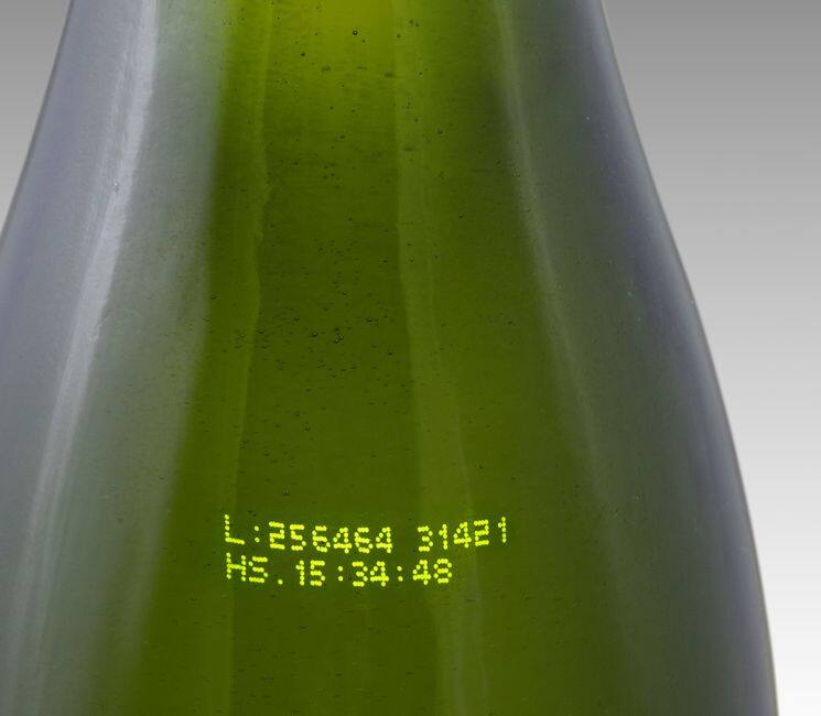 CIJ product marking: two line alpha-numeric code in yellow ink on a green glass bottle